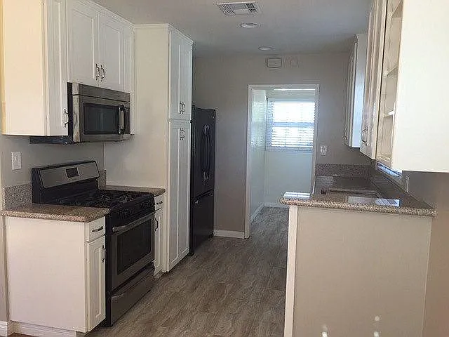 Kitchen and access to a Laundry Room with Window and exterior door.