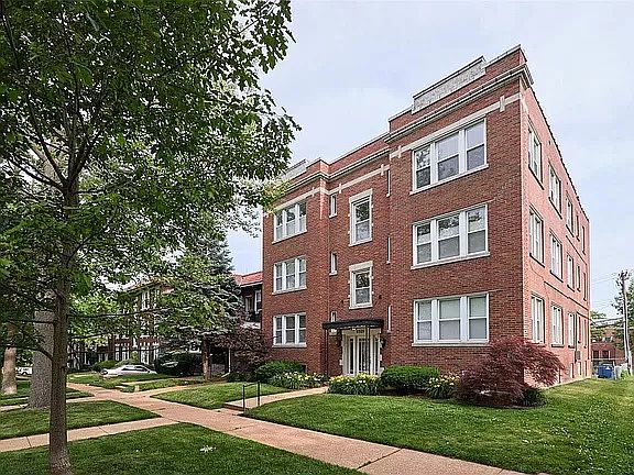 Front of building -- tree lined street