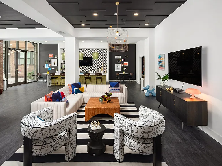Modern Clubroom with Bold Decor, Flat-Screen TV, and Open Lounge Layout