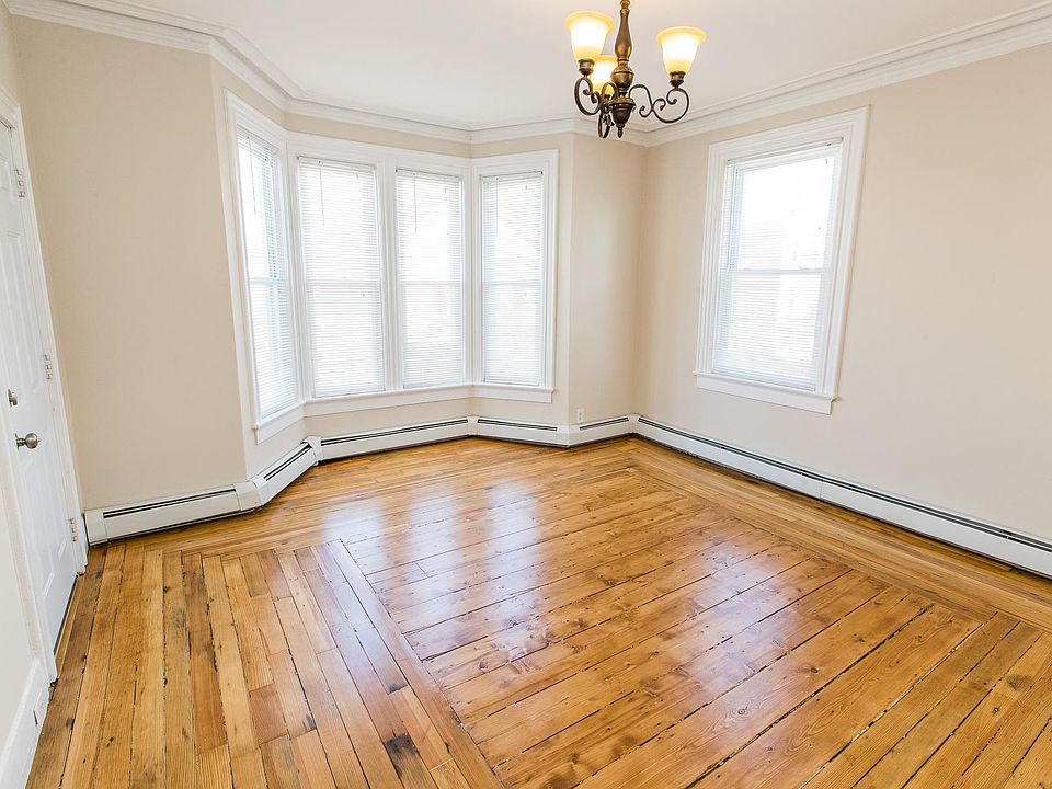 Parlor with gorgeous natural light and antique wood floors refinished with a European low VOC waterborne finish and restored to their natural beauty.