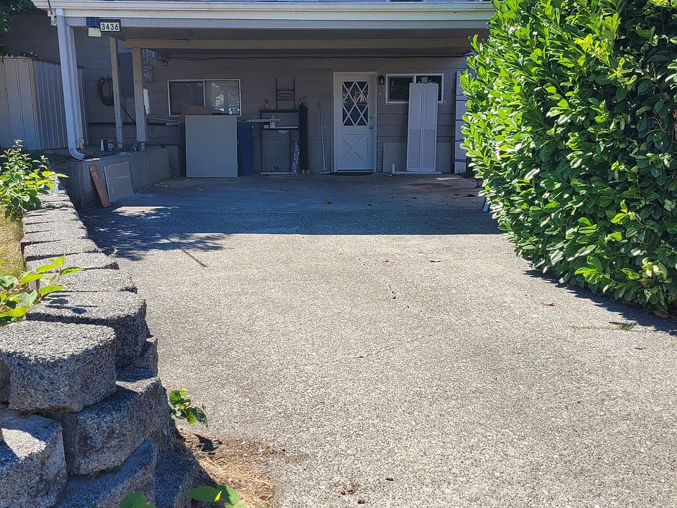 Picture taken before removal of all items. View from driveway/carport leading to front door.