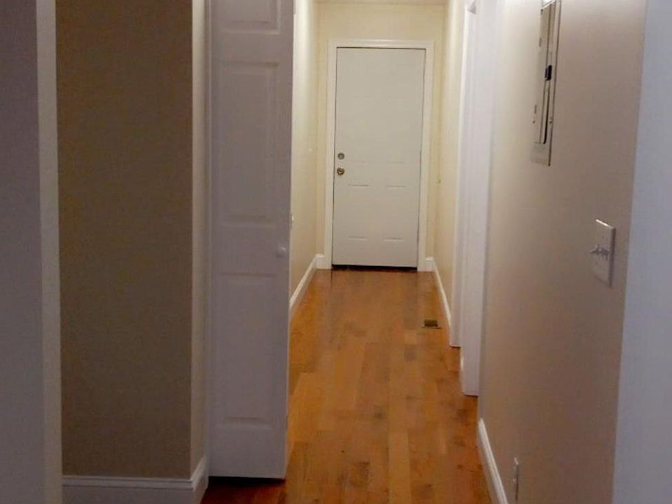 Hallway - where all the rooms, 1st full bath, the laundry area, and back exit door are located.