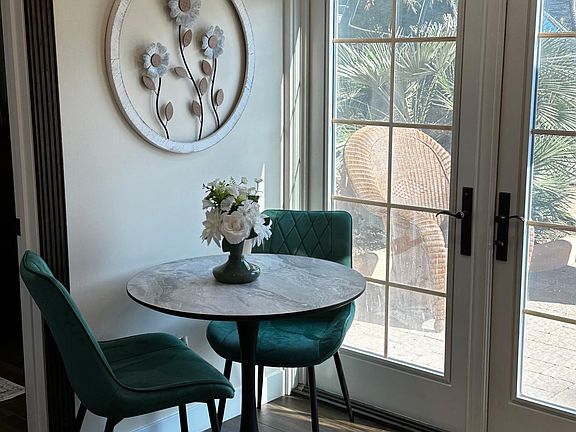 Table and chair - french doors leading to a nice outdoor patio