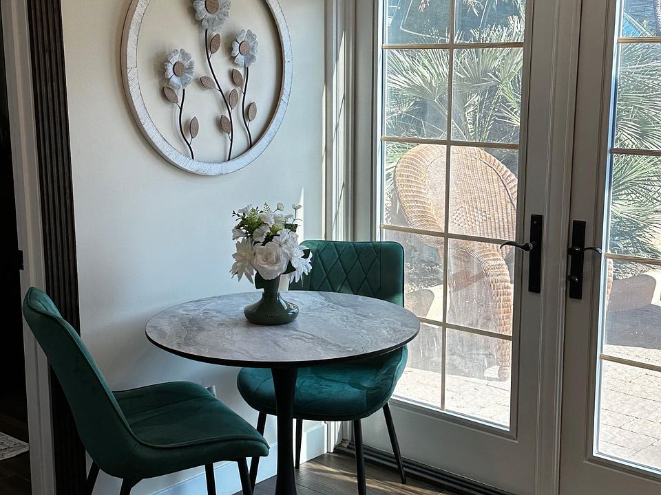 Table and chair - french doors leading to a nice outdoor patio