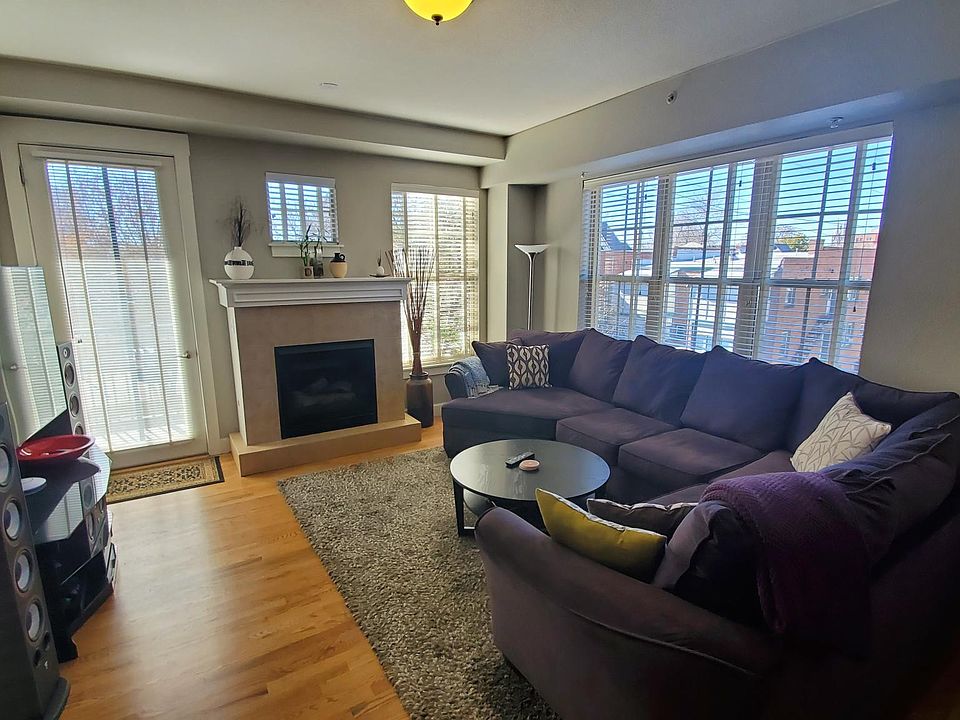 Living room with fireplace and door to balcony.