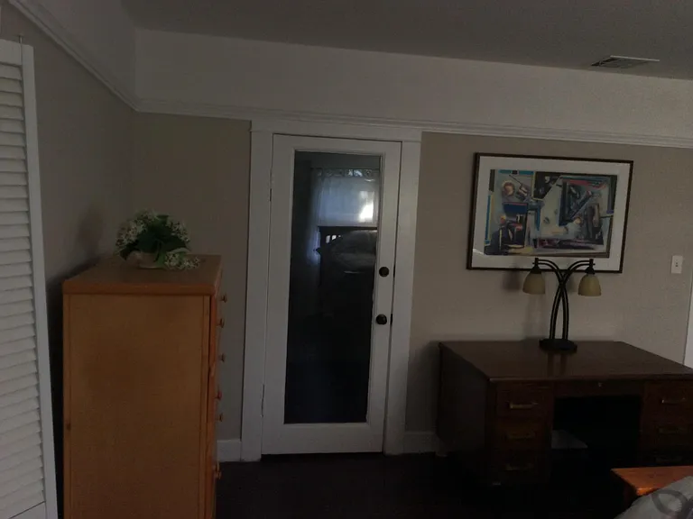 Master bedroom with door leading to large walk-in closet.