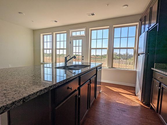 Central island upgraded to include garbage disposal. Natural light from the open view.