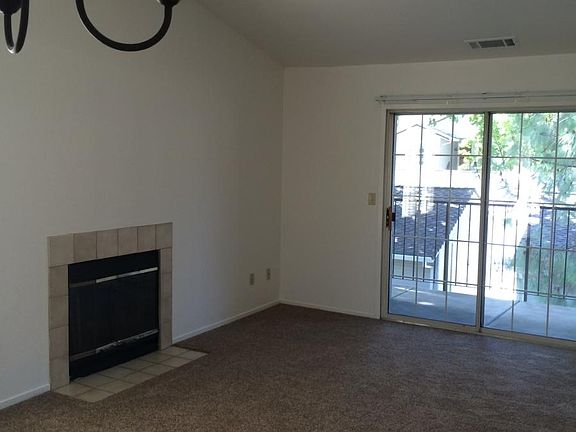 living room with fire place and balcony access