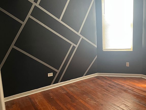Main bedroom - black accent wall will remain, all other walls to be painted white by availability date