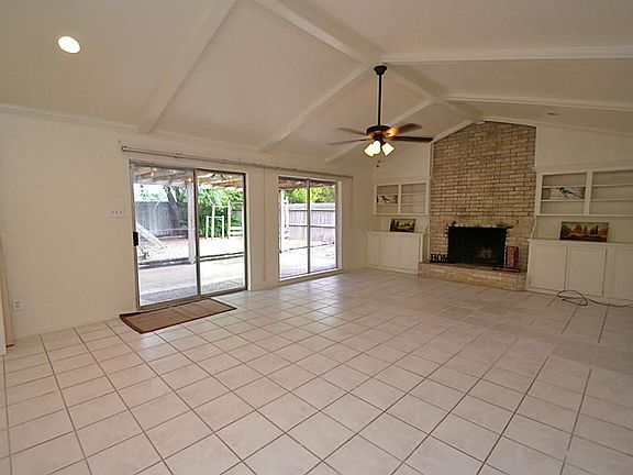  FAMILY ROOM...  The Family Room features tile floors, CATHEDRAL CEILINGS with BEAM accents, CEILING FAN with light fixture, a wood burning FIRE PLACE with BUILT IN BOOK SHELVES (on both sides) and a walk-in wet bar with a SINK!!