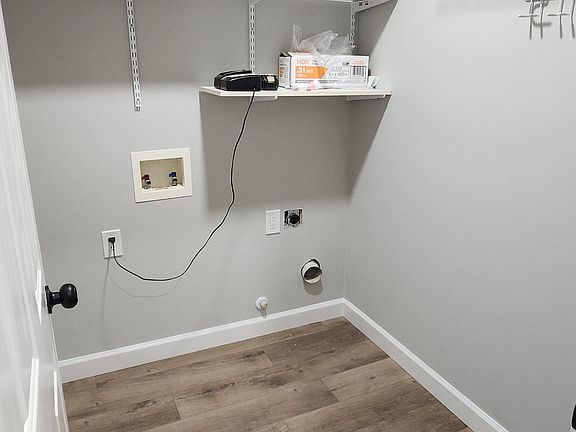 Spacious laundry room with washer/dryer hookups and plenty of storage