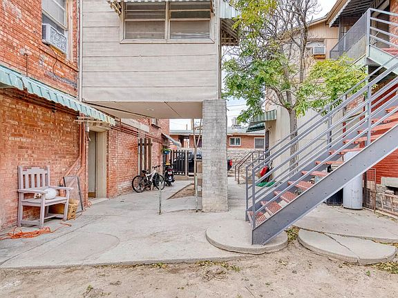 Photograph displaying the 4 unit building in the back, where Apartment 8 is located. Apartment 8 is the corner in the background of the photo.