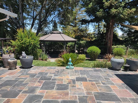 Back porch adjacent to family room/kitchen & master bedroom overlooking lawn and gazebo on deck