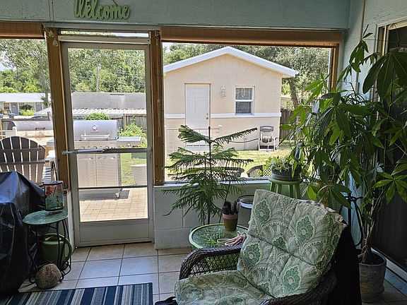 Screened in porch with outside patio and gas grill