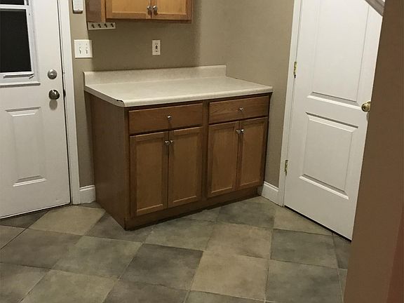 Large laundry area with extra storage and a half bath