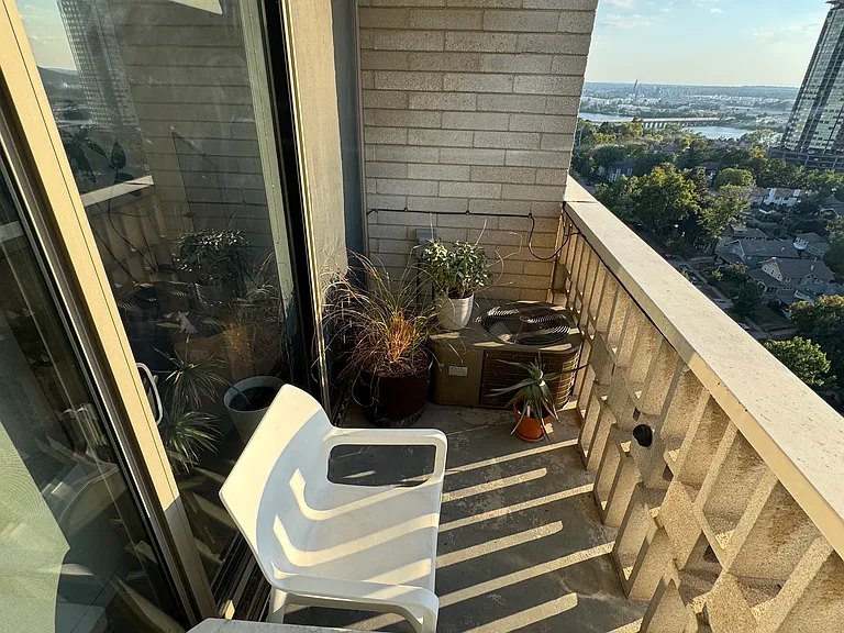 Sliding glass door provides easy access to private balcony.