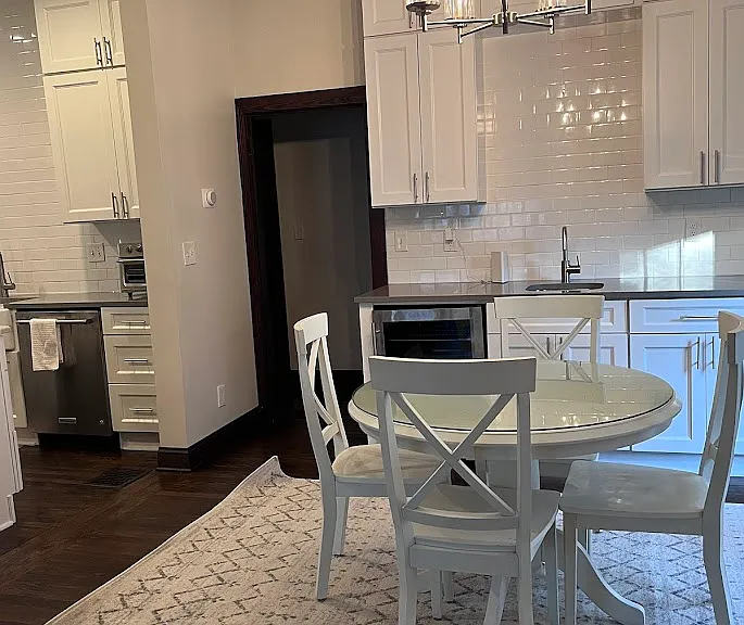 Dining room with functioning wet bar with sink and beverage refrigerator.