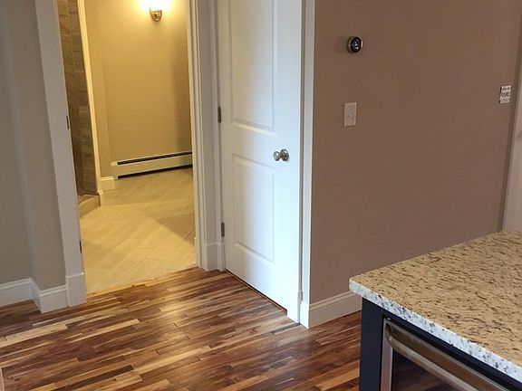 Bathroom with laundry unit behind door on right
