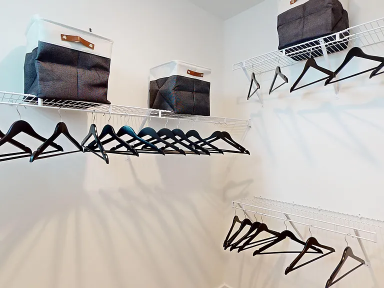 Spacious main bedroom closet with wire shelving