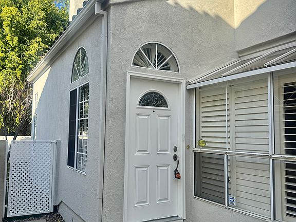 The front door is tucked by the walkway
