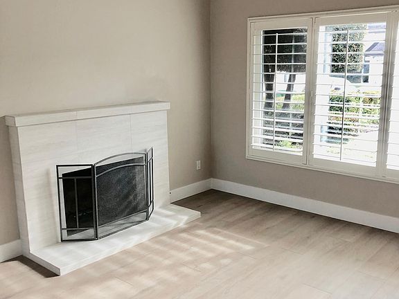 Living room with fireplace and plantation shutters