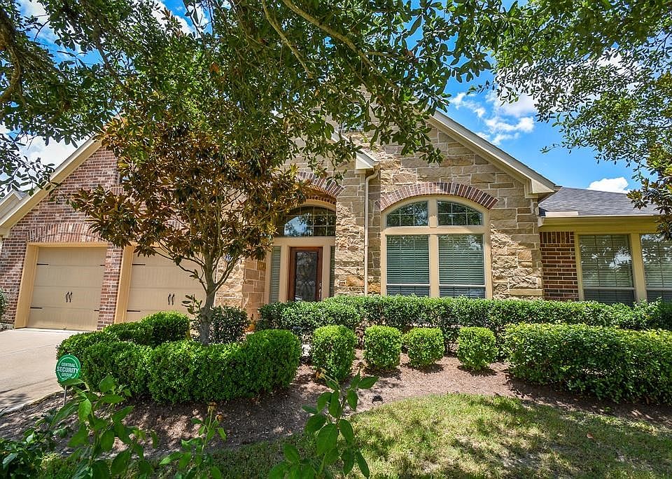 This hidden gem single story, stone and brick home is nestled among mature landscaping throughout the property.