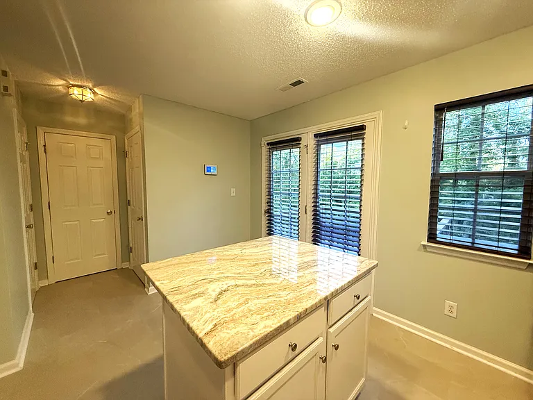 Laundry room, pantry, and powder room are all conveniently located.