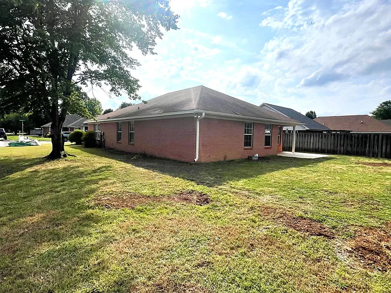 Back of house with yard