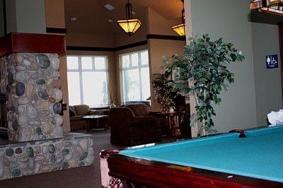 Wonderful Club House with Stone two sided fireplace, pool table, piano, library and more