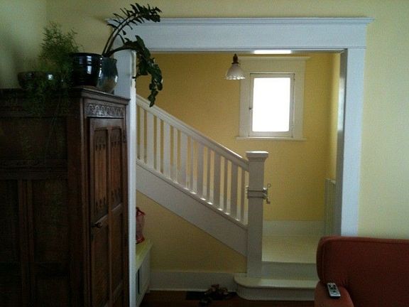 Farmhouse staircase and home entry way from living room