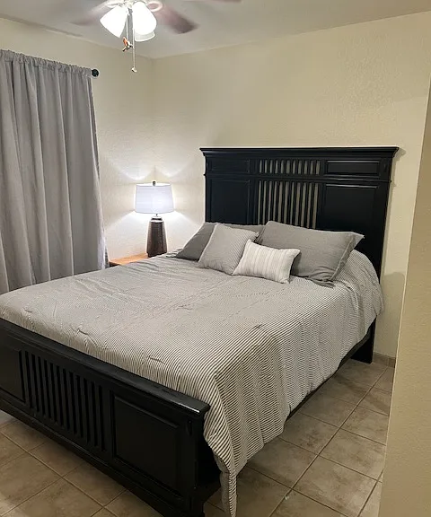 Queen size bed in guest bedroom.