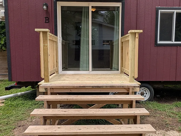 Steps up to lockable sliding door that allows for lots of natural light