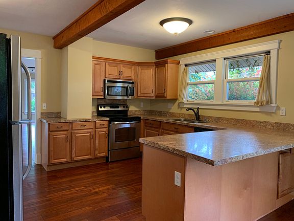 Updated kitchen with stainless appliances includes dining area and direct access to laundry mudroom off garage