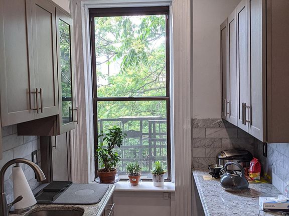 kitchen facing the garden - granite countertops, marble backsplash