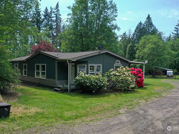 main house with beautiful flower bushes>