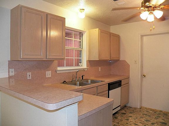 The kitchen has plenty of counter space & a breakfast bar