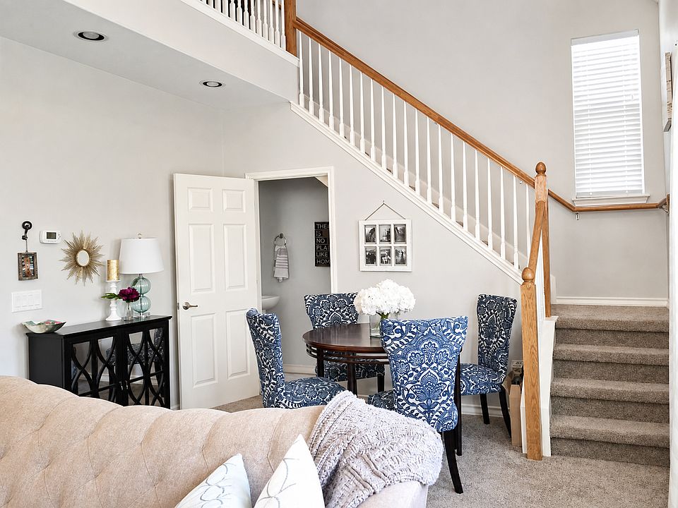 Living room with stairs to upstairs loft and bedroom. 1/2 bath under stairs.