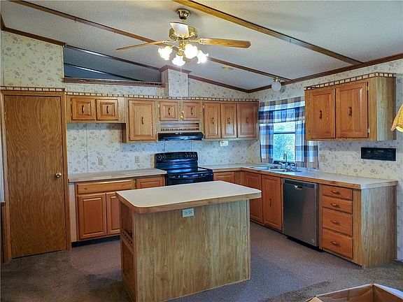 Kitchen with newer dishwasher. Electric stove stays.