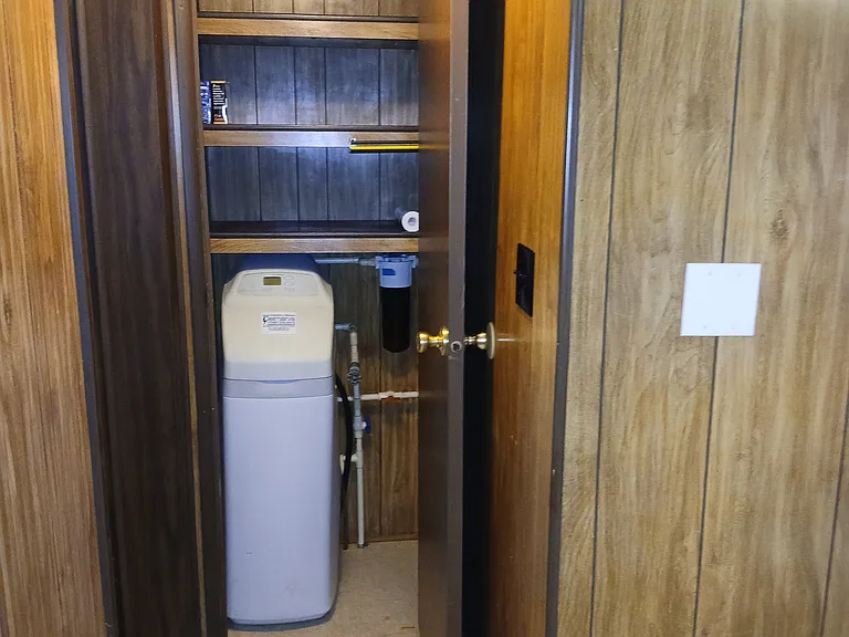Additional Closet Off of Kitchen with Water Softener and additional shelving