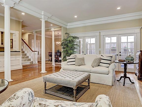 The living area also includes two sets of French doors leading to the well-maintained outdoor space.