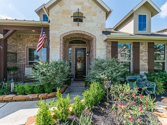 Warm and inviting front elevation with beautiful stacked stone and landscaping.
