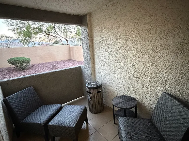 Private covered patio off the living room, perfect for morning coffee, fresh air, or relaxing outdoors