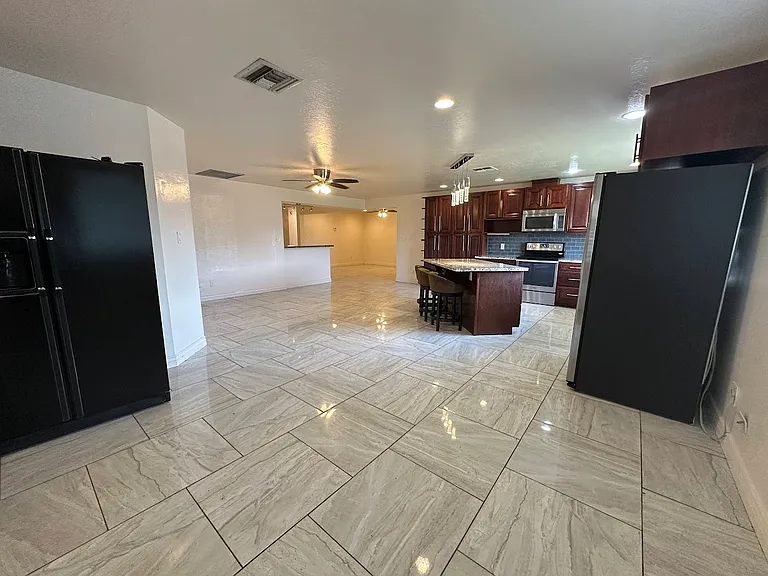 2 full size fridges with large kitchen and dining area