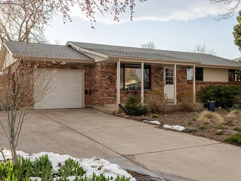 Two parking spaces, garage, and the front of the house.