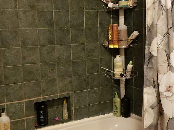 Hall bath with large soaking tub, granite counter with double sinks.