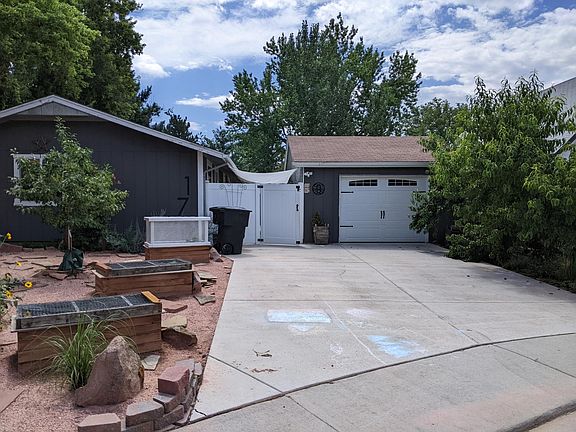 Brand-new garage door with remotes, new fencing/gate in front (both sides), three raised beds, and peach trees give some extra shade in summer.