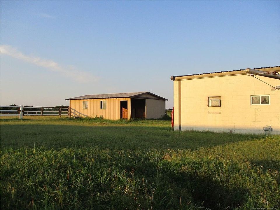 The apartment has the air conditioner and is at the far end of the barn