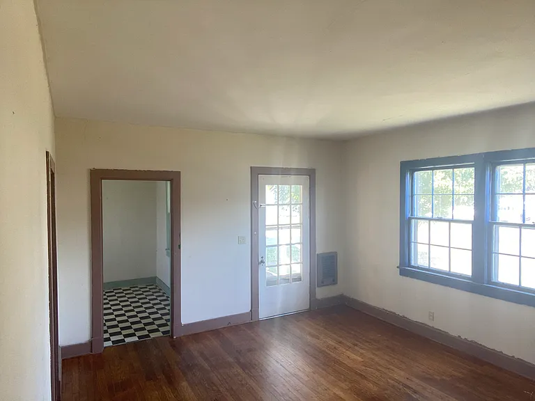 Living Room looking at main entry and kitchen door