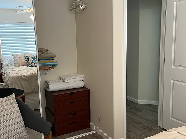 2nd bedroom with a dresser inside the closet