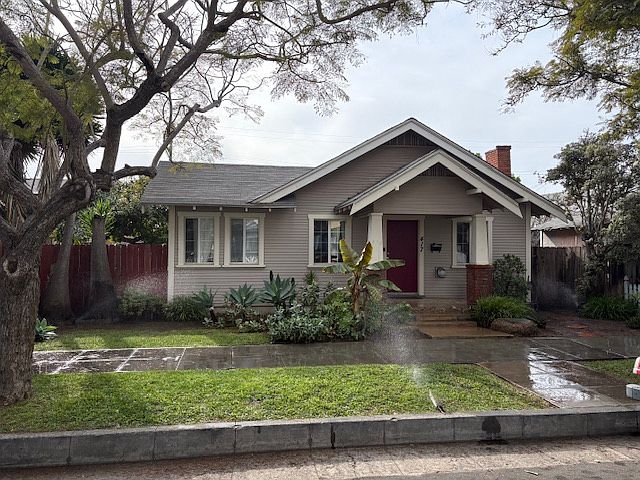 Front of house with sprinklers on